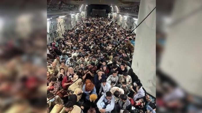 Shocking picture: At least 600 stacked on a military plane to leave the country