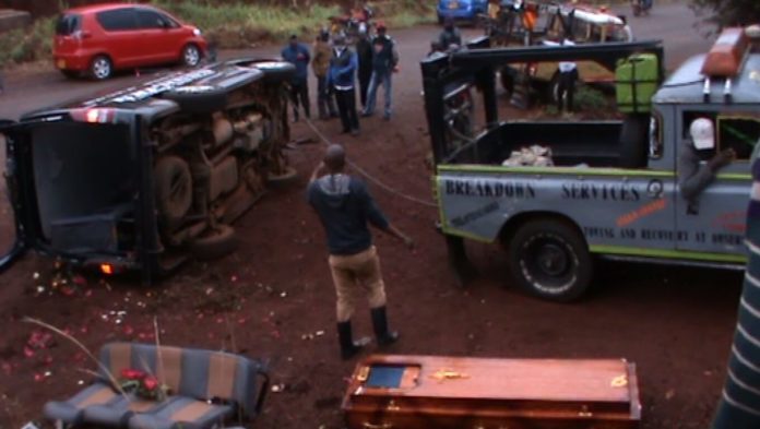 Hearse carrying a coffin overturns smashes into a pedestrian